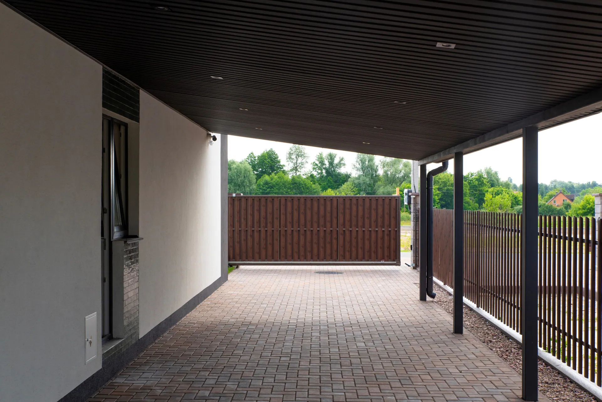 Covered patio with metal canopy, brick paving