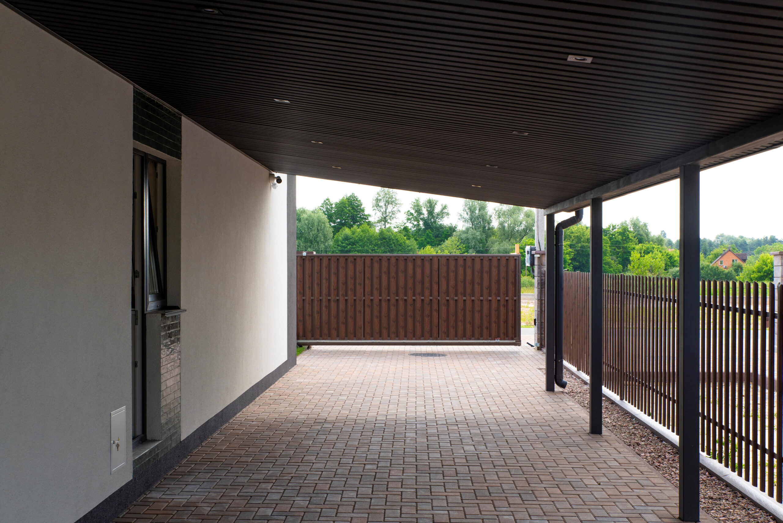 Covered patio with metal canopy, brick paving