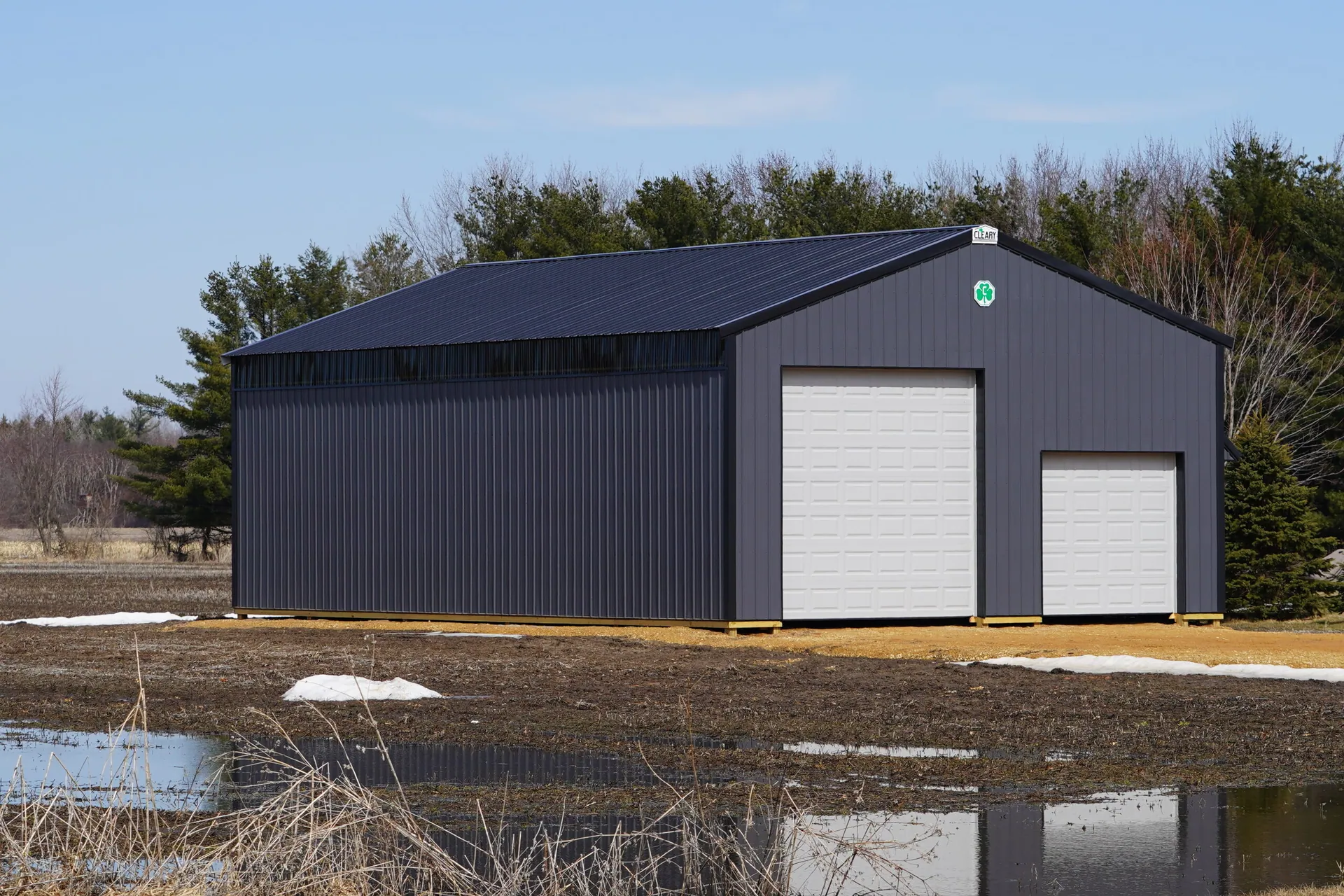 Large metal black storage unit sits on roadside holding owner belongings.